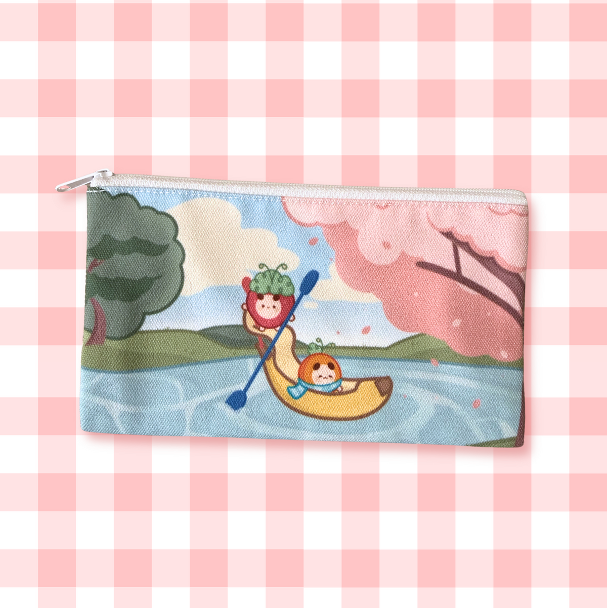 A rectangular zip pouch with a colorful cartoon illustration of two characters in a banana boat on water, set against a pink and white gingham checkered background.